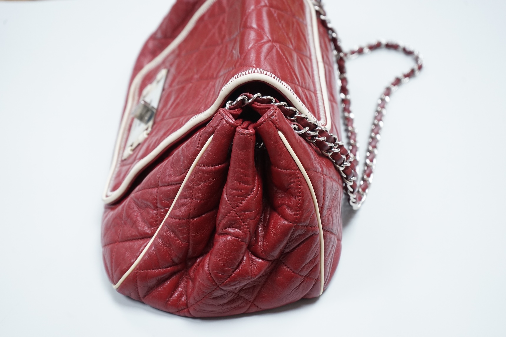 A Chanel East West dark red quilted leather flap shoulder bag with silver hardware, date code 12115484, with original receipt, dust cover and box, 35cm wide, Provenance: purchased by the vendor in Selfridges